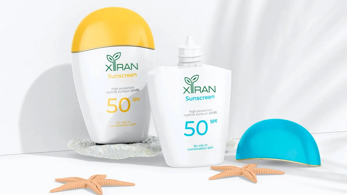 XIRAN sunscreen bottles with SPF 50 for oily or combination skin, featuring a yellow cap and a beach-themed decoration.